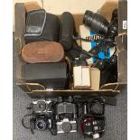 A quantity of mixed cameras and lenses.