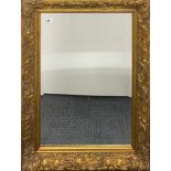 An Art Nouveau style gilt framed bevelled edge mirror, frame size 90 x 94cm.
