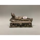 A bronze figure of the reclining Buddha, L. 24cm.