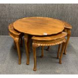 A 1930's circular walnut nest of five tables, dia. 76cm, H. 52cm.