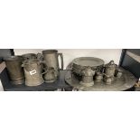 A group of five early pewter tankards, together with a large pewter tray, plate warmers etc, tray