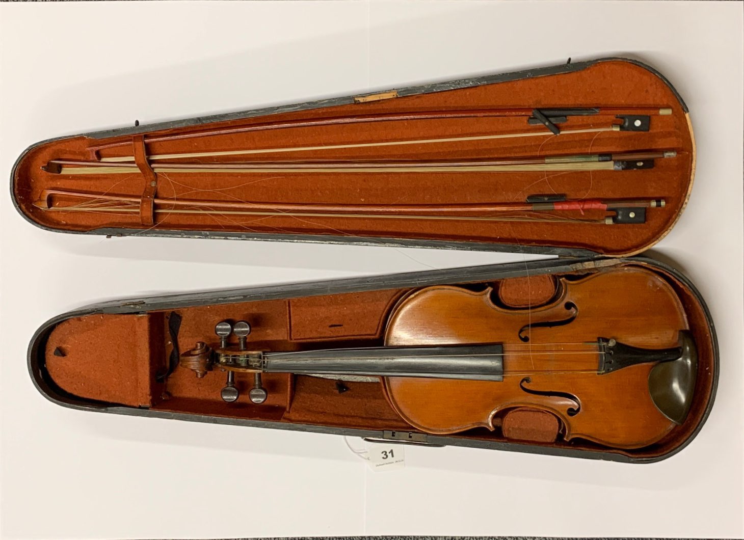 An antique cased violin with three bows, with a hand written label reading Emanuel Whitmarsh, London