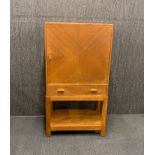 A 1930's Cotswold style light oak cabinet, 61 x 38 x 114cm.