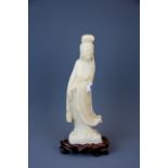 A lovely early 20th century carved soapstone figure of the goddess Guan Yin standing on a carved