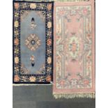 Two washed wool Chinese rugs, largest 154 x 75cm.