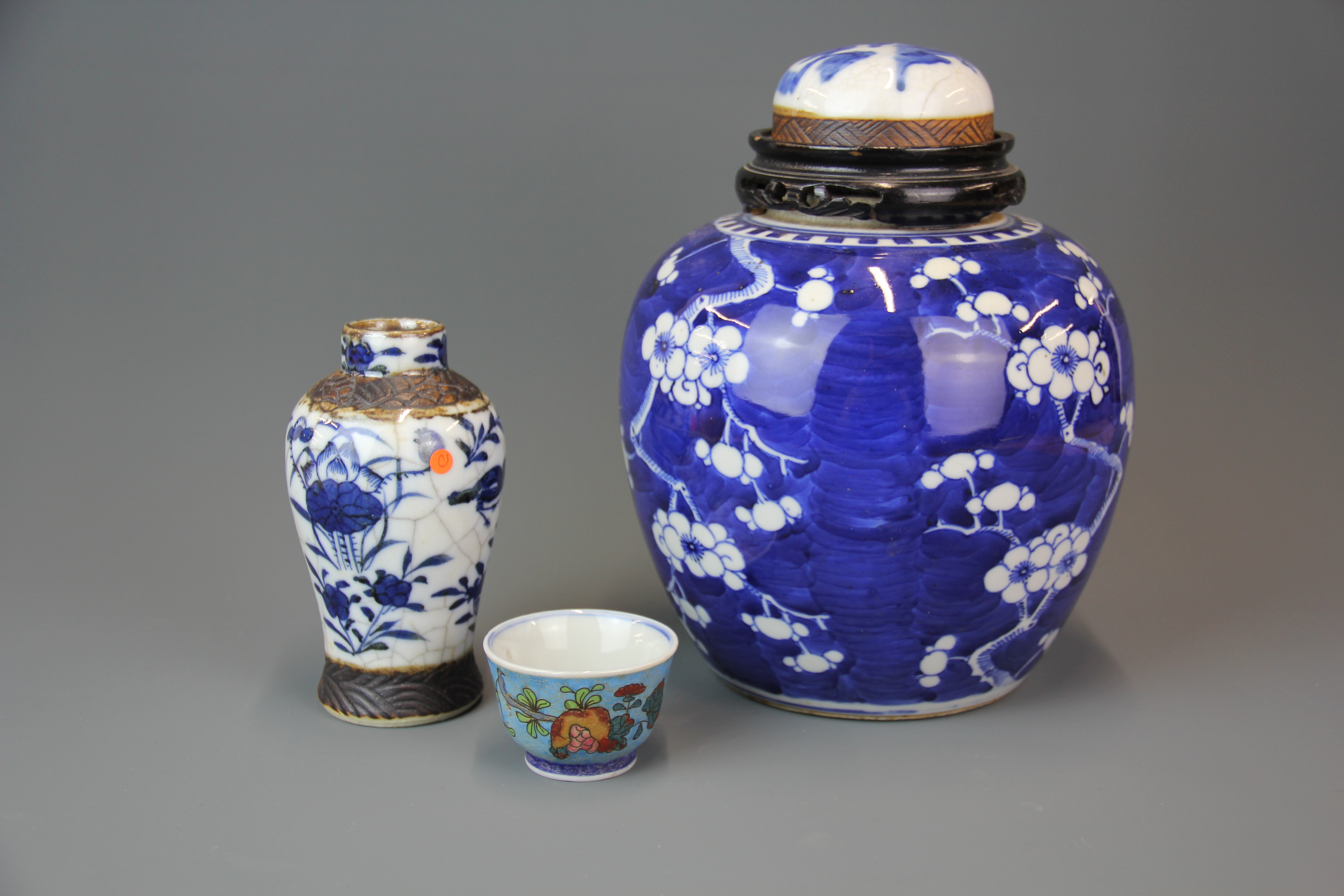 A 19th century Chinese porcelain jar with alternative lid, together with a similar period