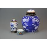A 19th century Chinese porcelain jar with alternative lid, together with a similar period
