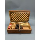 A Victorian oak games box and contents.