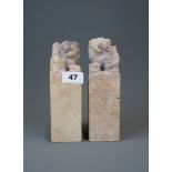 A pair of Chinese carved soapstone seals mounted with lion dogs, H. 19cm.