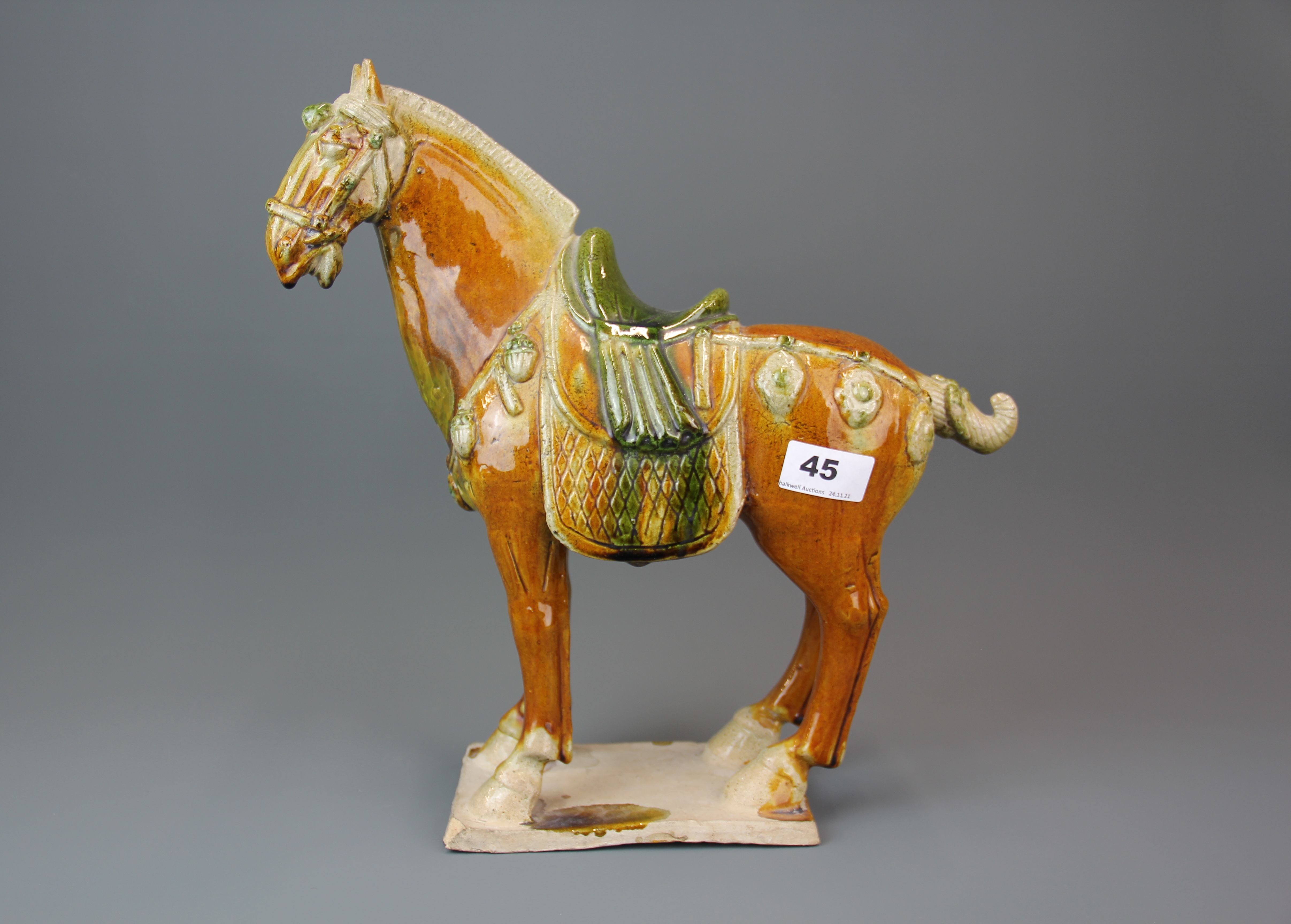 A Chinese Tang Dynasty style glazed pottery horse, H. 35cm.