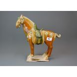 A Chinese Tang Dynasty style glazed pottery horse, H. 35cm.
