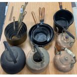 A set of brass pans, cast iron pans etc.