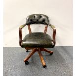 A button backed leather upholstered mahogany desk chair.