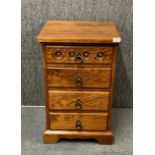 A contemporary heavy quality four drawer oak bedside cabinet, 45 x 45 x 70cm.