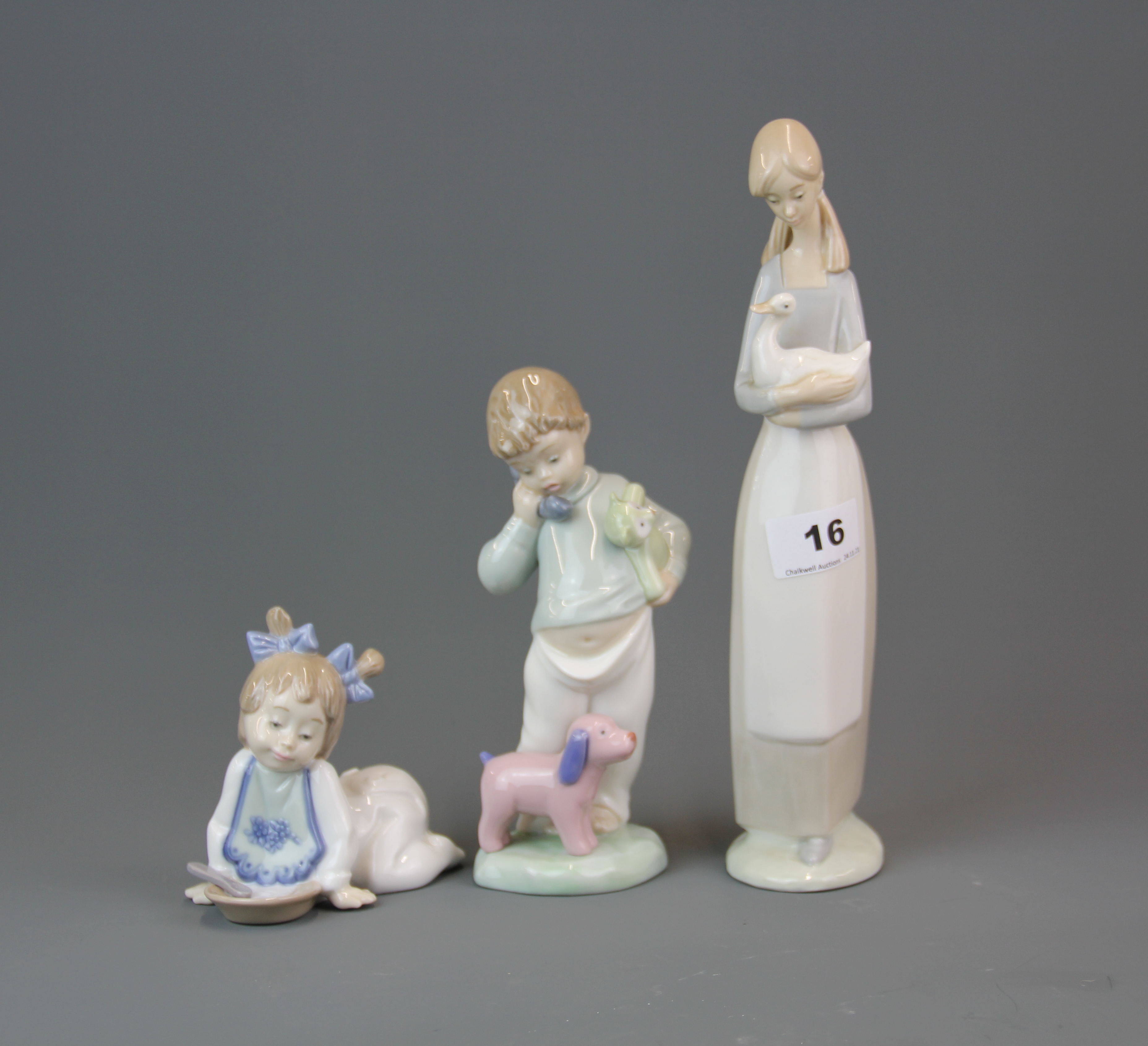 A group of three Nao figures, tallest H. 27.5cm.