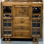 A 1930's carved oak bureau bookcase, 119 x 33 x 112cm.