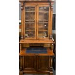 An early 19th century mahogany and flame veneered escritoire bookcase, 111 x 230cm.