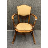A small upholstered Arts and Crafts chair, 56 x 81cm.