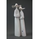 A Lladro figure of two nuns #4611 retired 2001, H. 34cm.