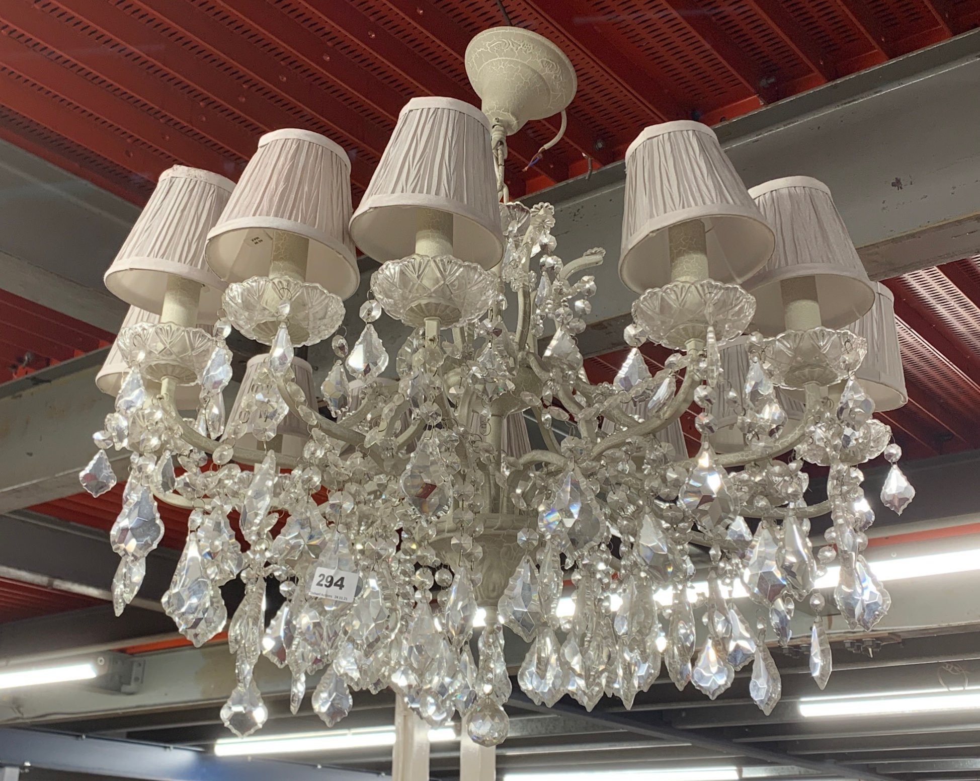 A large twelve branch metal and crystal drop chandelier light fitting, Dia. 82cm, D. 76cm.