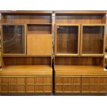 Two 1970's teak display cabinets, one incorporating a drop down bar, each is 120 x 193cm.