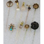 A collection of Edwardian and other yellow metal stick pins.