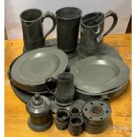 A group of five early pewter tankards, together with a large pewter tray, plate warmers etc, tray