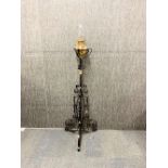 A Victorian telescopic wrought iron and brass oil lamp with a spare chimney, H. 151cm (with