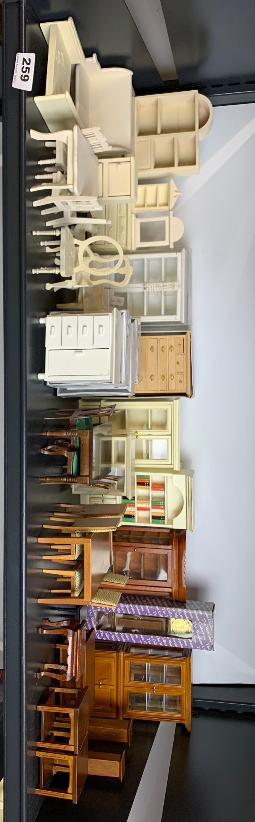 A large quantity of wooden dolls house living room furniture items.