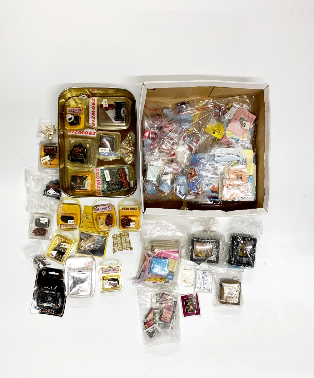 A quantity of boxed wired dolls house fire places including some fire place ornaments, together with