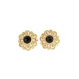 A pair of 14ct yellow gold (stamped 585) flower shaped stud earrings set with oval cut garnets, L.