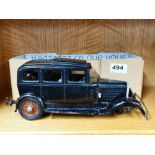 An early (c. 1930) model of a four door saloon car with bakelite body on a pressed metal chassis and