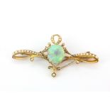 A yellow metal (tested high carat gold) brooch set with a cabochon cut opal and seed pearls, approx.