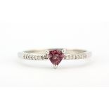 A hallmarked 9ct white gold ring set with a trillion cut pink tourmaline and diamond set