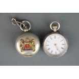 A ladies silver fob watch together with a white metal sovereign case.