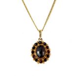 A 14ct yellow gold chain with a yellow metal (tested minimum 9ct gold) garnet set pendant, L. 42cm.