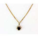 A hallmarked 9ct yellow gold chain with a hallmarked 9ct yellow gold pendant set with a heart shaped