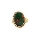 A 9ct yellow gold ring set with a large cabochon oval cut bloodstone, (M).