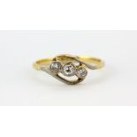 An antique 18ct yellow gold crossover ring set with three diamonds, (N). Approx. 2gr.