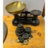 A brass and cast iron kitchen scale and weights.
