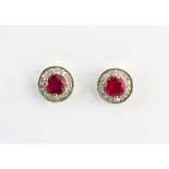 A pair of 9ct yellow gold (stamped 9k) earrings set with round cut rubies surrounded by diamonds,