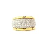 An 18ct yellow and white gold ring pave set with brilliant cut diamonds, (O).