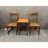 A pair of Edwardian cane seated bedroom chairs and a small oak side table.