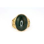 A hallmarked 9ct yellow gold ring set with a large cabochon oval cut bloodstone, (S.5). Approx. 8.