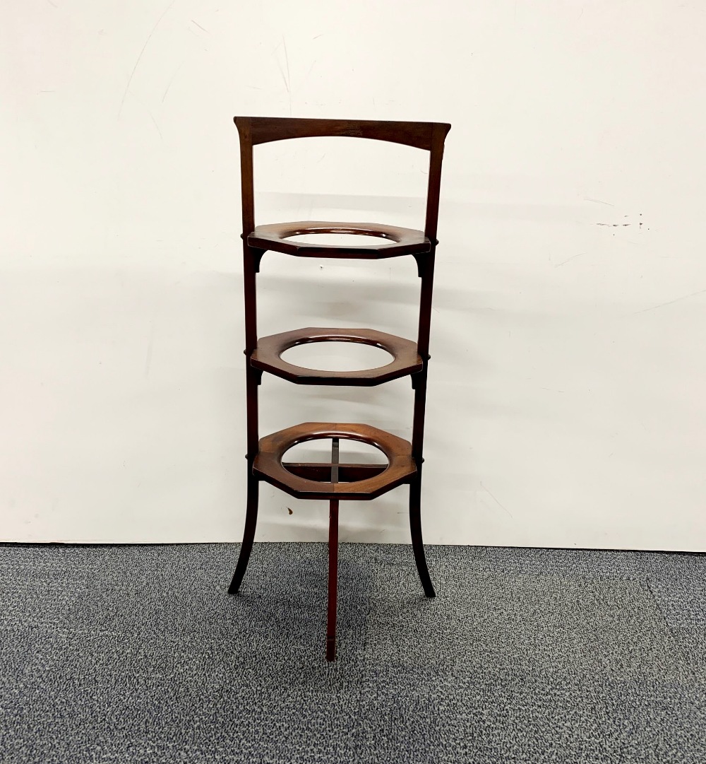 An Edwardian mahogany folding cake plate stand, H. 79cm.