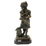 A large bronze figure of a girl with puppies on a black marble base, H. 51cm.