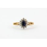 A 9ct yellow gold sapphire and diamond set cluster ring, (L.5).