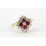 A hallmarked 18ct yellow gold cluster ring set with rubies and brilliant cut diamonds, (O).