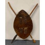 An African tribal shield and weapons, H. 83cm.