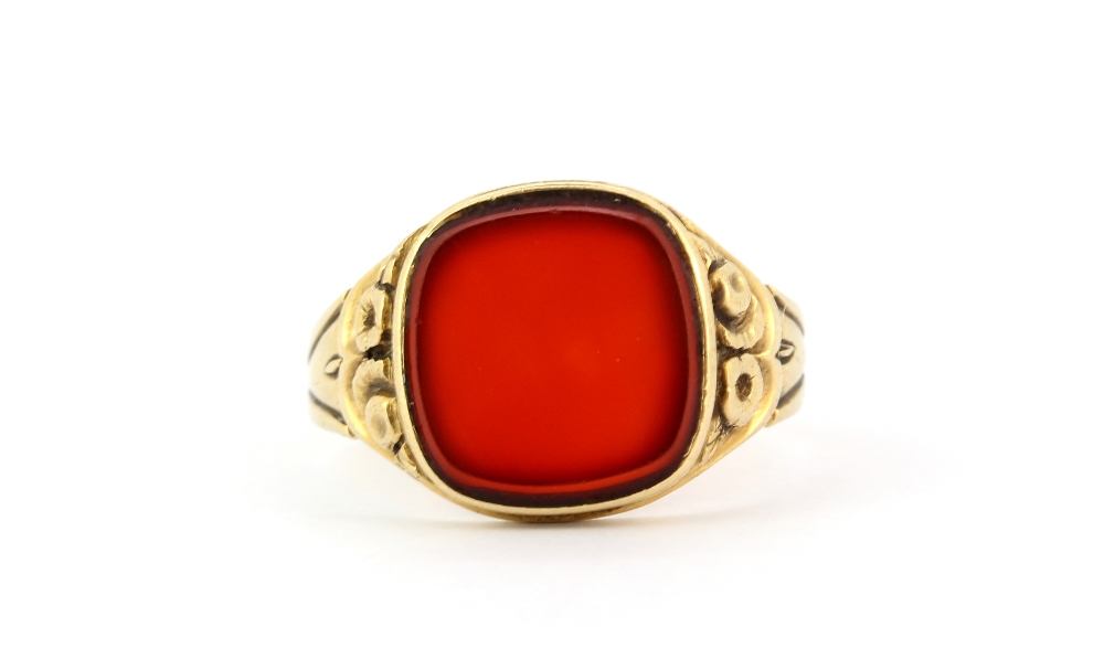 A gentleman's yellow metal (tested minimum 9ct gold) signet ring set with carnelian, (Y).